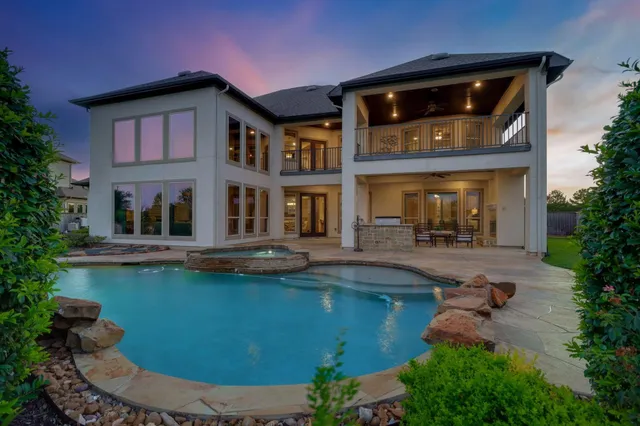 a house view with swimming pool and garden space