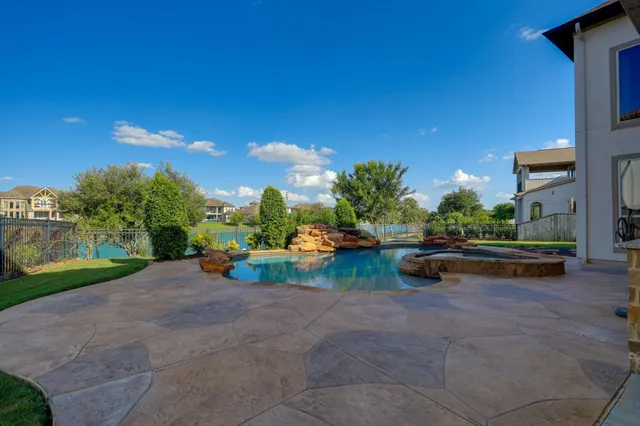 a view of a backyard with plants and a patio