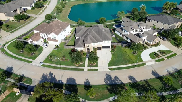 an aerial view of a house with a yard