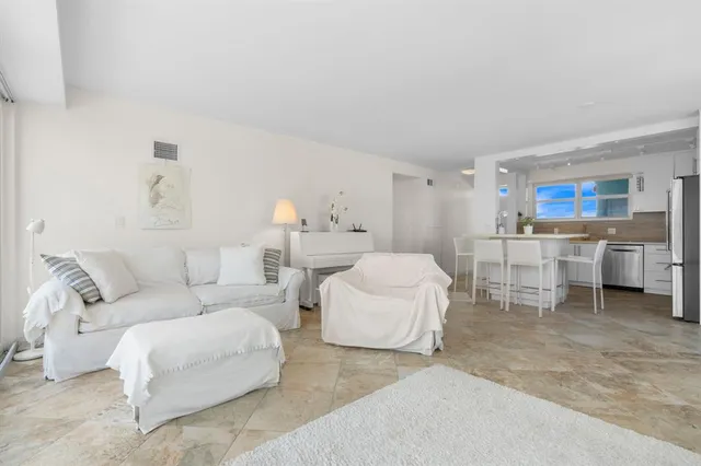 a living room with furniture and a lamp