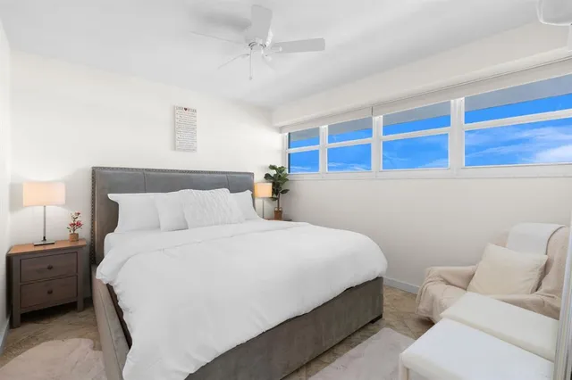 a bed room with a bed and a chair