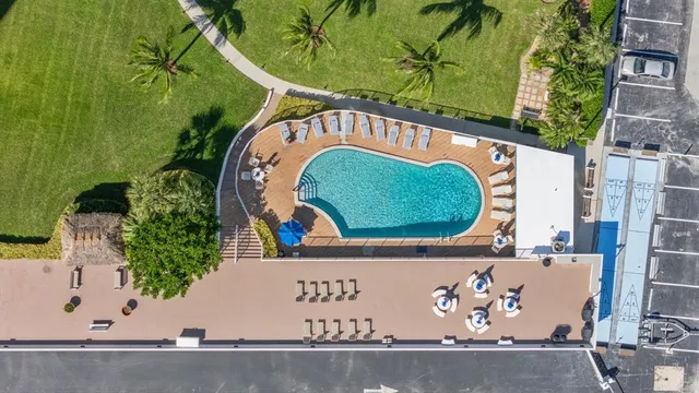 a living room with furniture a chandelier and a dining table