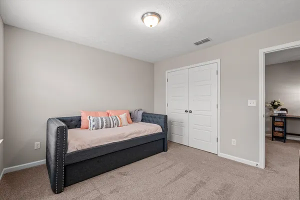 a bedroom with a bed and a table