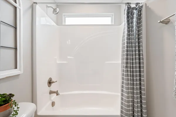 a bathroom with a bathtub and shower