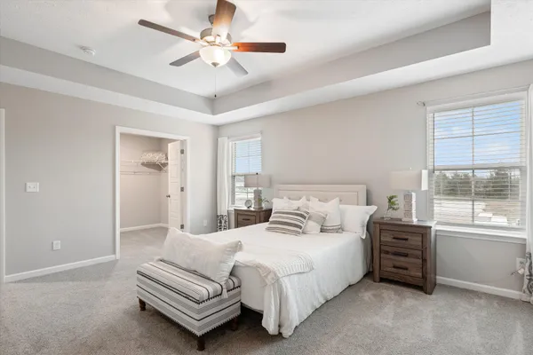 a spacious bedroom with a bed a window and closet