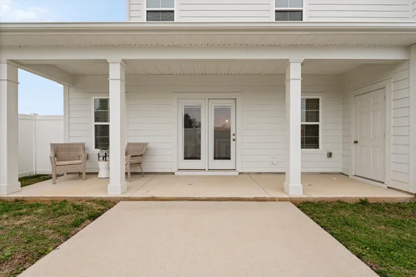 a front view of a house with chairs
