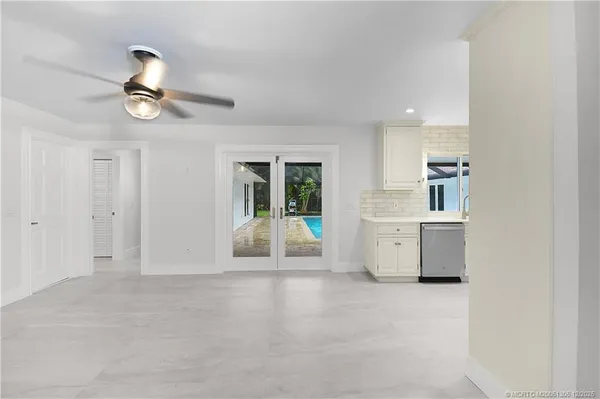 a kitchen with granite countertop white cabinets and white appliances