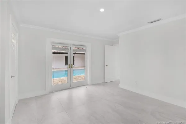 an empty room with windows and closet