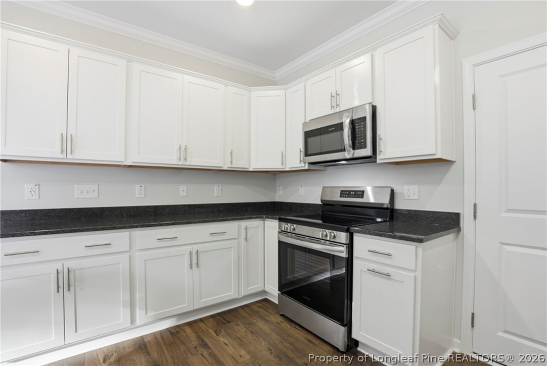 106 Knotts Berry Road Bunnlevel, NC 28323 - Photo 21 of 50 a kitchen with granite countertop white cabinets and stainless steel appliances