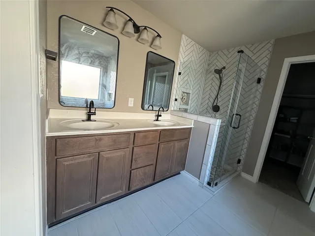 a bathroom with a double vanity sink mirror and double