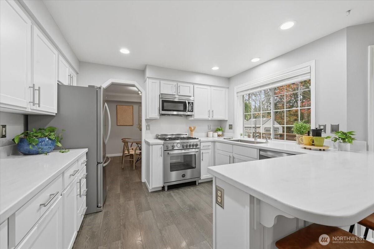 13802 60th Avenue West Edmonds, WA 98026 - Photo 16 of 36 a kitchen with a sink stove and refrigerator