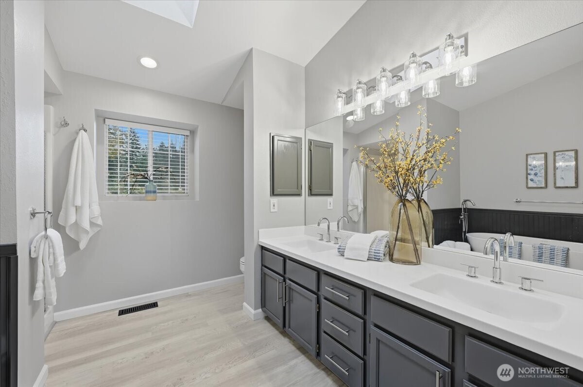 13802 60th Avenue West Edmonds, WA 98026 - Photo 22 of 36 a bathroom with double vanity and a mirror