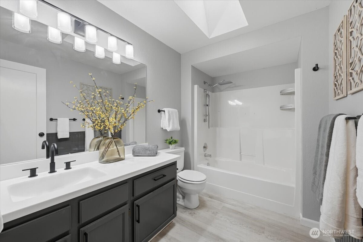 13802 60th Avenue West Edmonds, WA 98026 - Photo 25 of 36 a bathroom with a double vanity sink toilet mirror and bathtub
