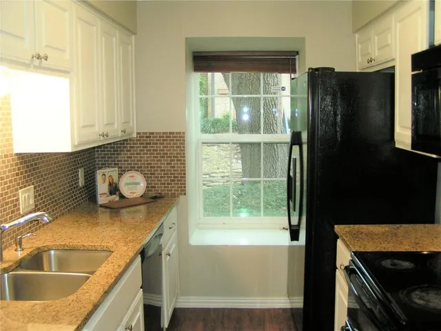 a bathroom with a sink a bathtub and next to a window