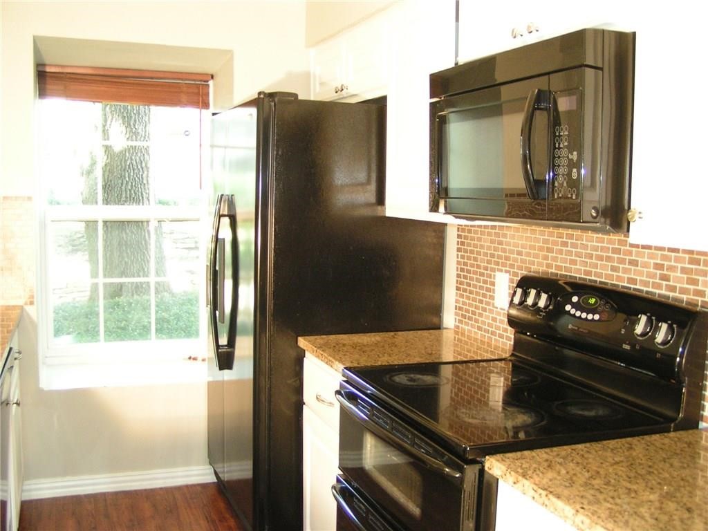 6627 Valleyside Road Austin, TX 78731 - Photo 14 of 32 a kitchen with a refrigerator and a stove