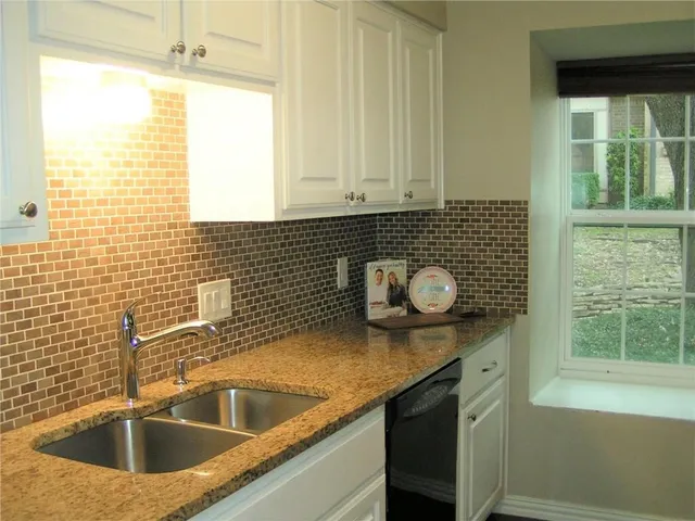 a kitchen with a sink and a window
