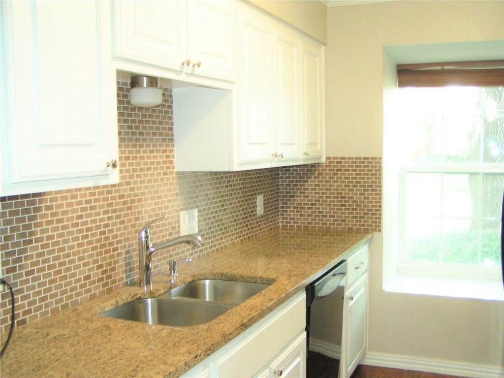 6627 Valleyside Road Austin, TX 78731 - Photo 17 of 32 a bathroom with a sink a mirror and a shower