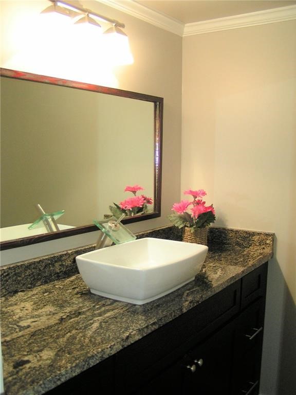 6627 Valleyside Road Austin, TX 78731 - Photo 19 of 32 a bathroom with a granite countertop sink and a mirror