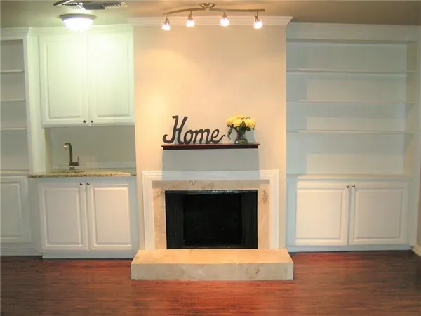a view of a livingroom with a fireplace and a window