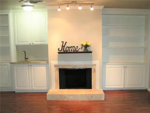 a view of a livingroom with a fireplace and a window