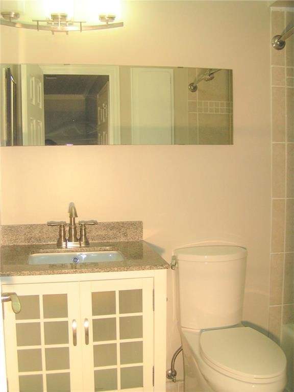 6627 Valleyside Road Austin, TX 78731 - Photo 25 of 32 a bathroom with a toilet sink and mirror