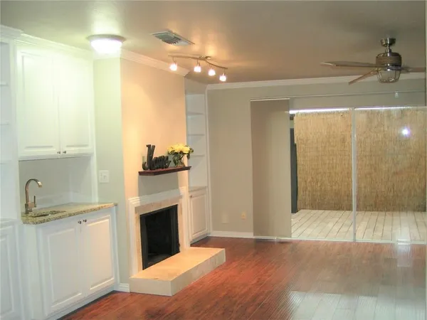 a view of a kitchen with a sink and a refrigerator