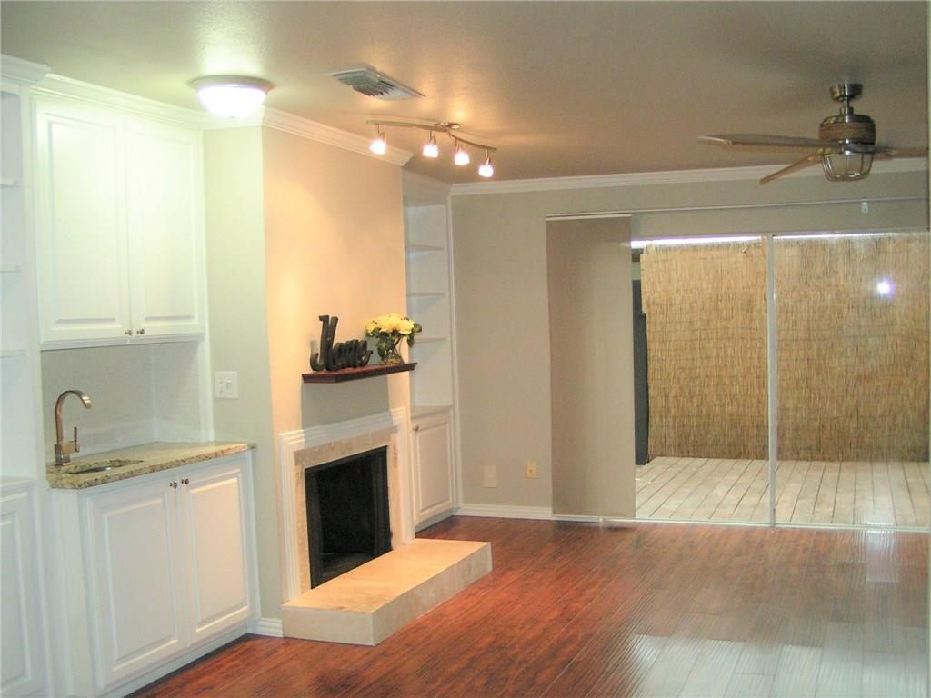6627 Valleyside Road Austin, TX 78731 - Photo 6 of 32 a view of a kitchen with a sink and a refrigerator
