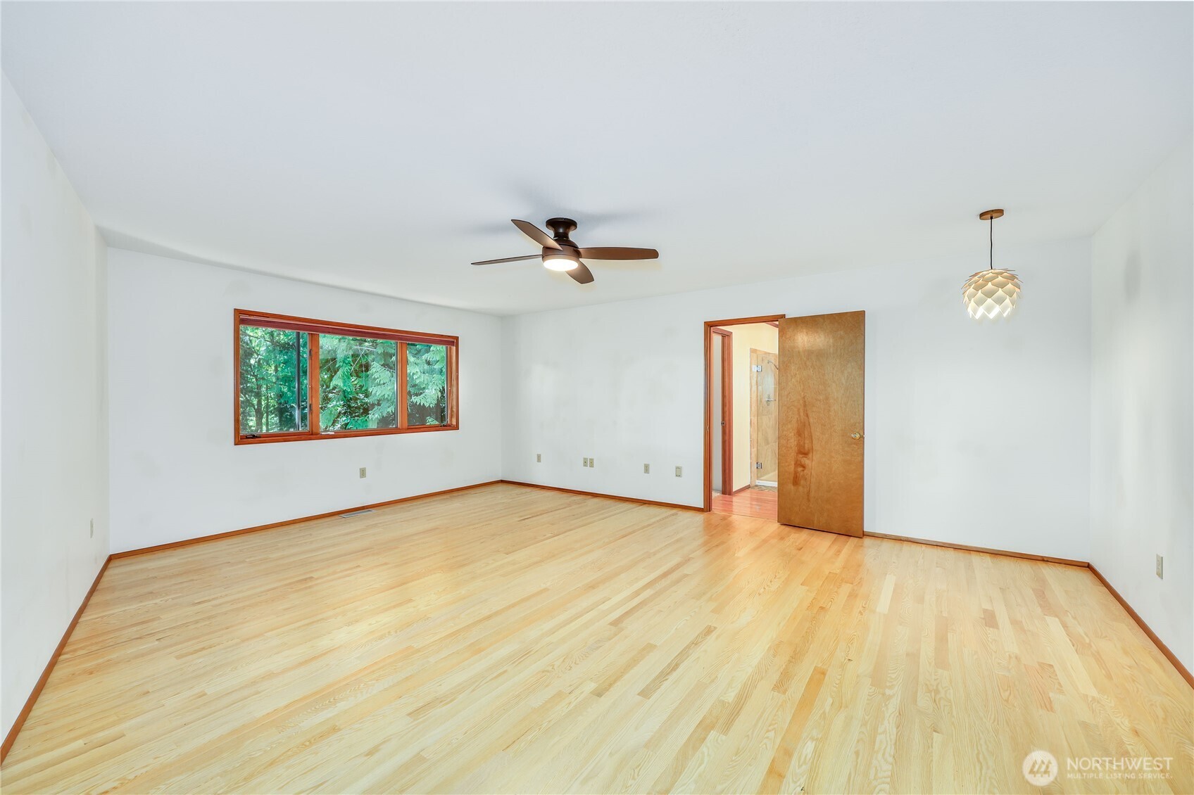 11 Bishop Hill Road Chimacum, WA 98325 - Photo 17 of 34 a view of an empty room with wooden floor and a window
