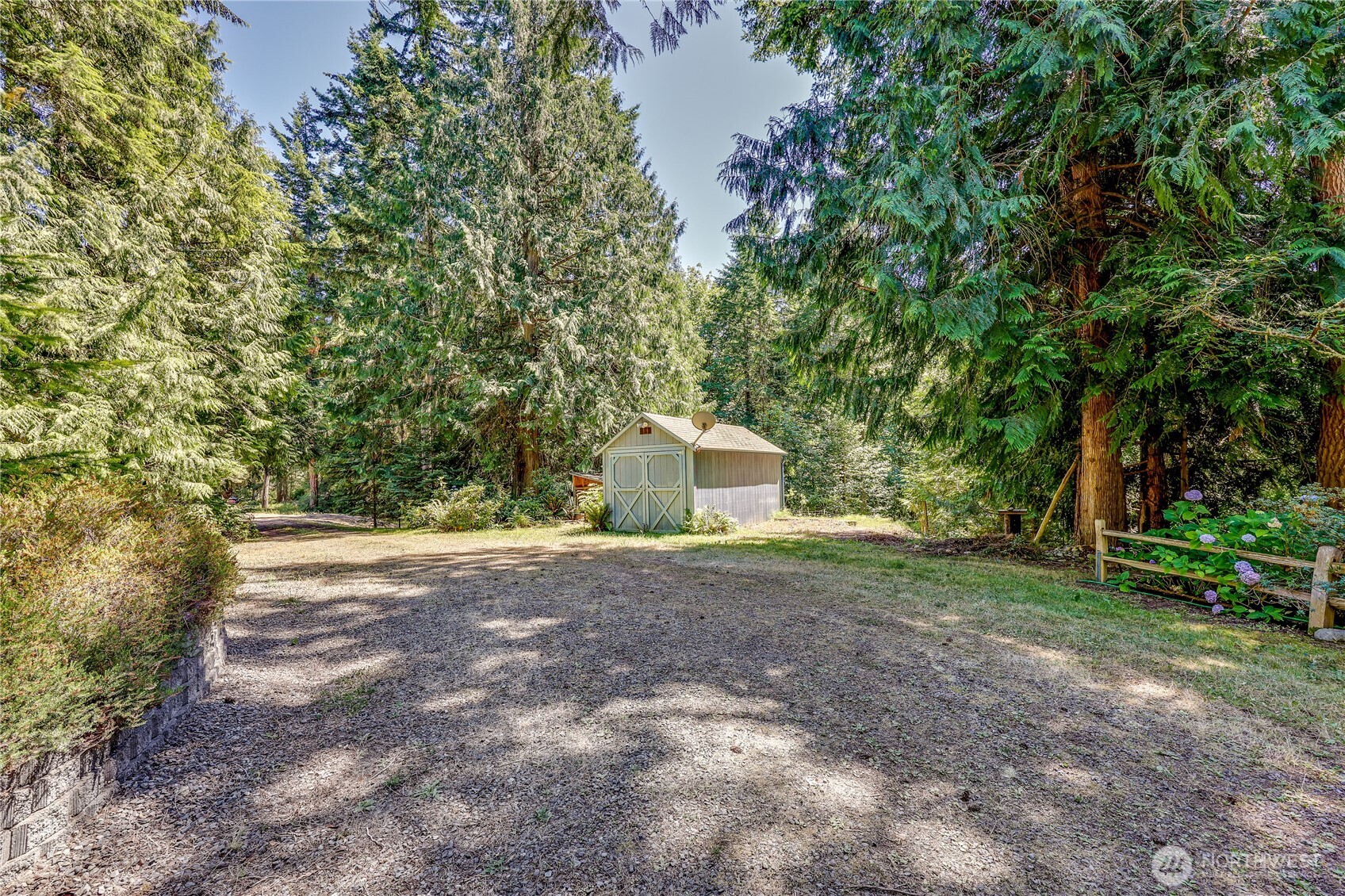 11 Bishop Hill Road Chimacum, WA 98325 - Photo 32 of 34 a backyard of a house with trees and outdoor seating