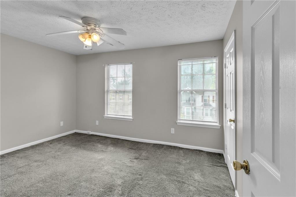 5910 Hampton Court Atlanta, GA 30349 - Photo 16 of 23 an empty room with windows and chandelier