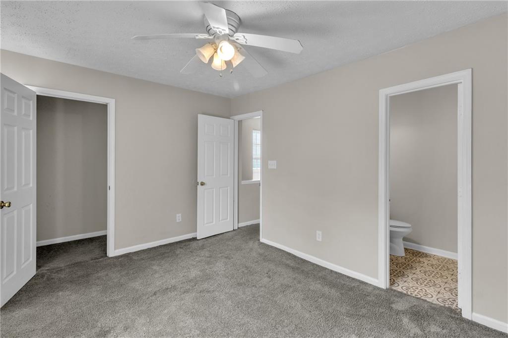 5910 Hampton Court Atlanta, GA 30349 - Photo 17 of 23 a view of a room with a ceiling fan and bathroom space