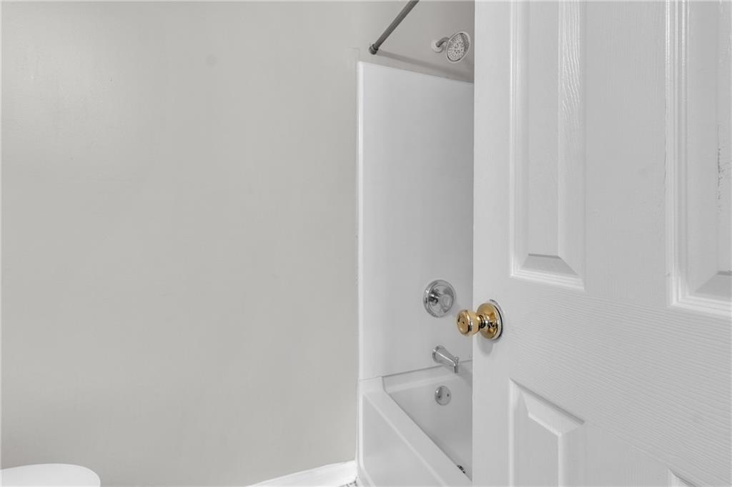 5910 Hampton Court Atlanta, GA 30349 - Photo 19 of 23 a bathroom with a bathtub