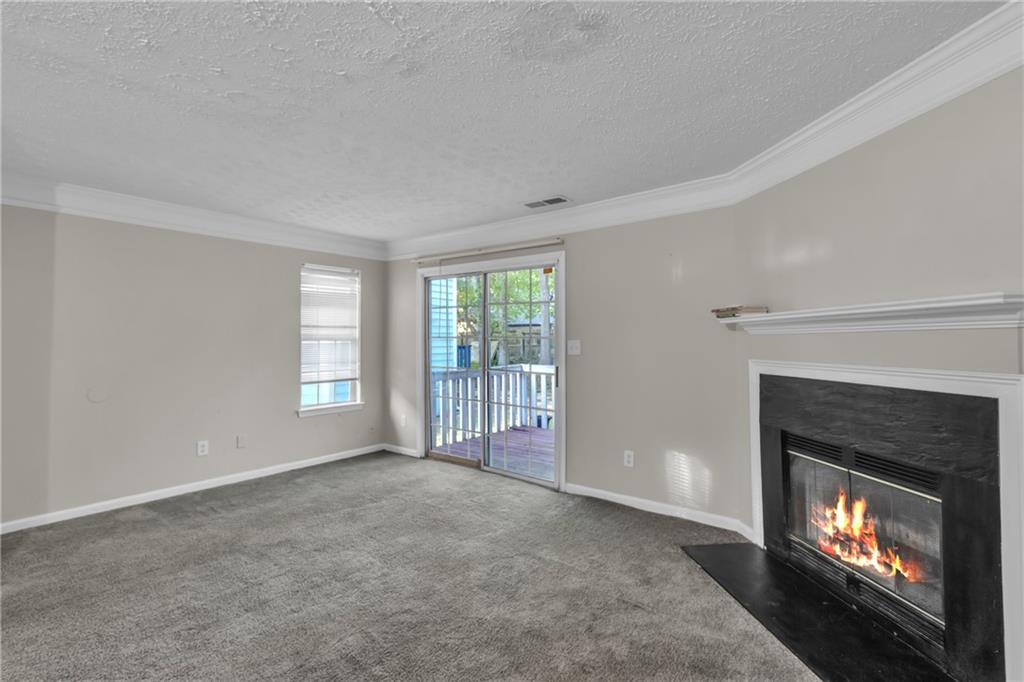 5910 Hampton Court Atlanta, GA 30349 - Photo 2 of 23 a view of an empty room with a fireplace