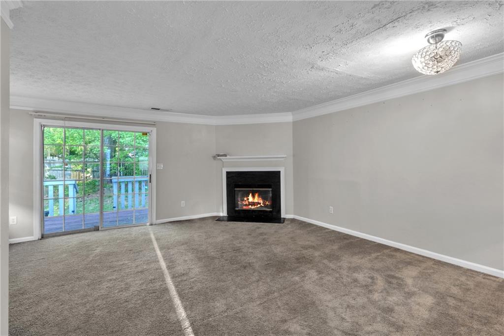 5910 Hampton Court Atlanta, GA 30349 - Photo 3 of 23 a view of an empty room with a fireplace and a window