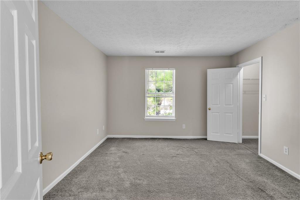 5910 Hampton Court Atlanta, GA 30349 - Photo 10 of 23 an empty room with windows