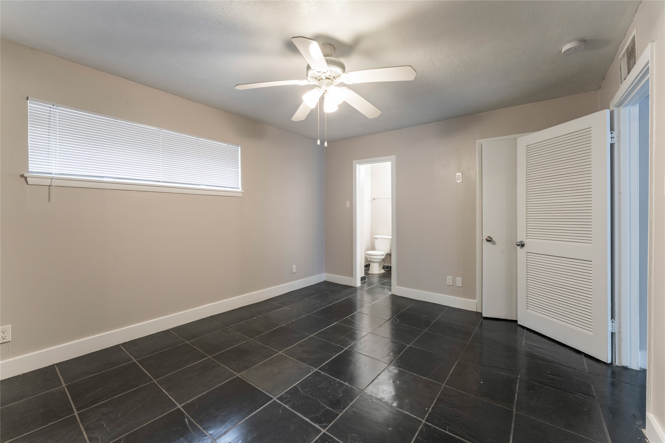 420 West Alabama Street, Unit 10 Houston, TX 77006 - Photo 1 of 9 an empty room with white walls and ceiling fan