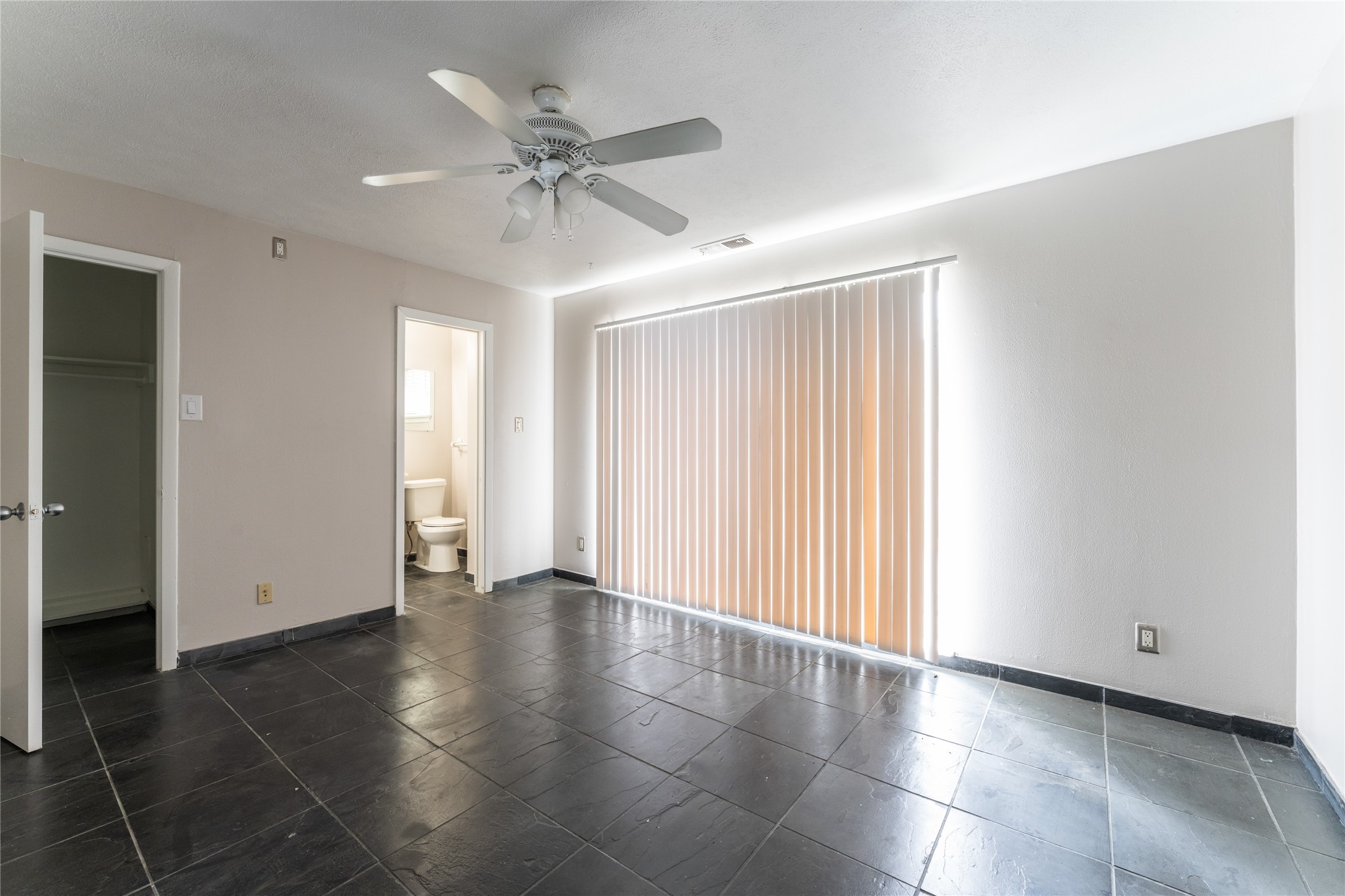 420 West Alabama Street, Unit 10 Houston, TX 77006 - Photo 2 of 9 an empty room with wooden floor closet and windows