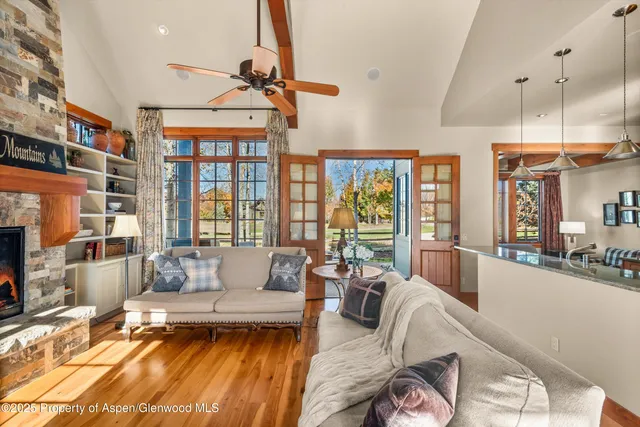 a view of a patio with couches potted plants and a big yard