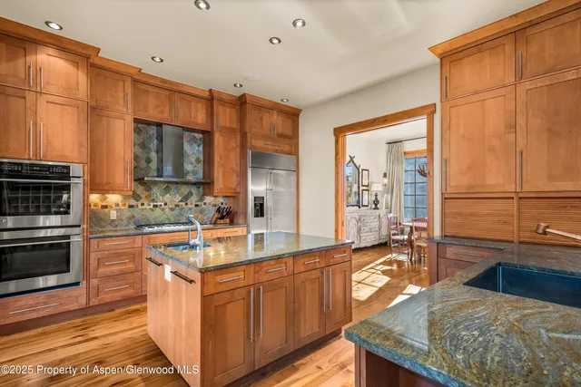 a kitchen with stainless steel appliances granite countertop a sink and cabinets