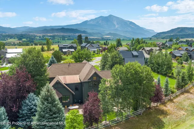 an aerial view of a house with mountain view