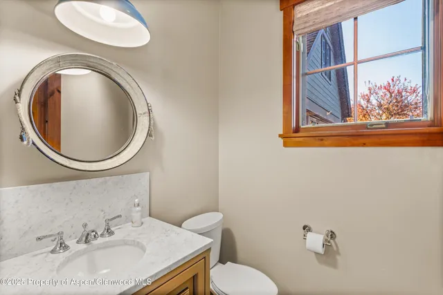 a bathroom with a shower sink and mirror
