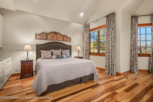 a bathroom with a granite countertop sink toilet and mirror