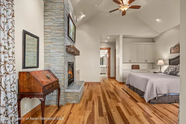 a bedroom with a large bed and a desk