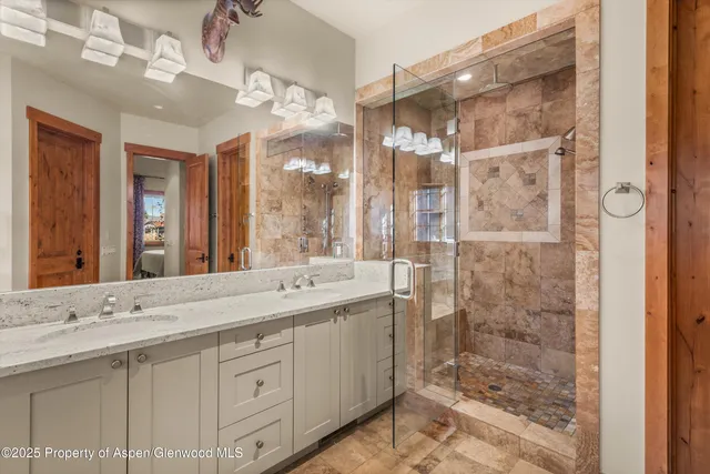 a bathroom with a granite countertop sink a toilet a mirror a shower and a bathtub