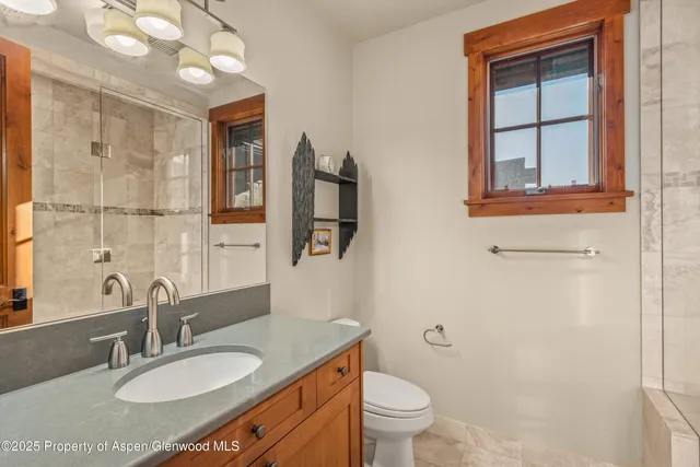 an aerial view of a houses with a yard and lake view