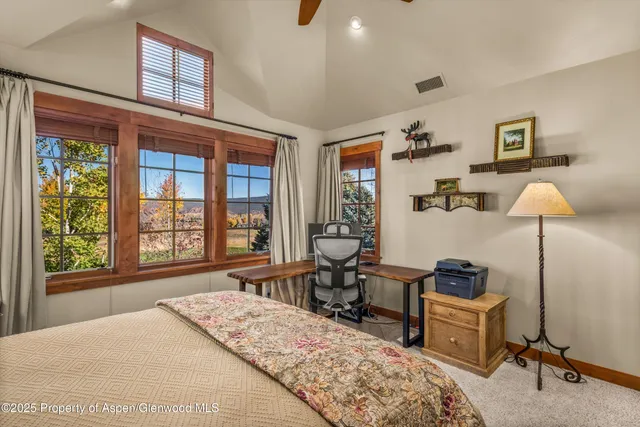 an aerial view of residential houses with outdoor space and mountain view in back
