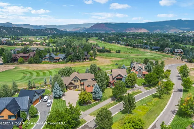 a patio with couches and a table and chairs with garden view