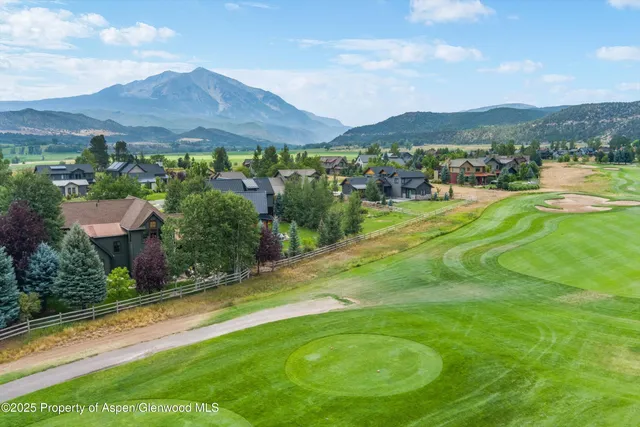 a view of a patio with table and chairs and potted plants with wooden floor and fence