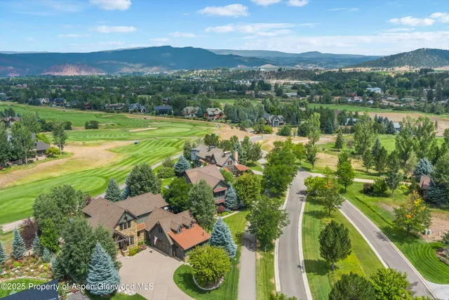 a view of a house with backyard sitting area and garden