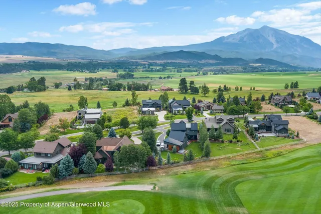 a view of a house with backyard sitting area and garden